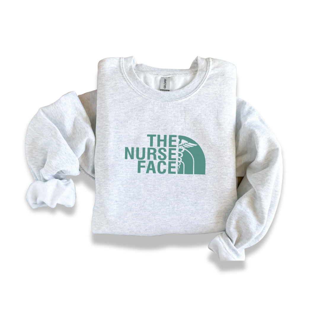 The Nurse Face Teal Crewneck Sweatshirt Unisex