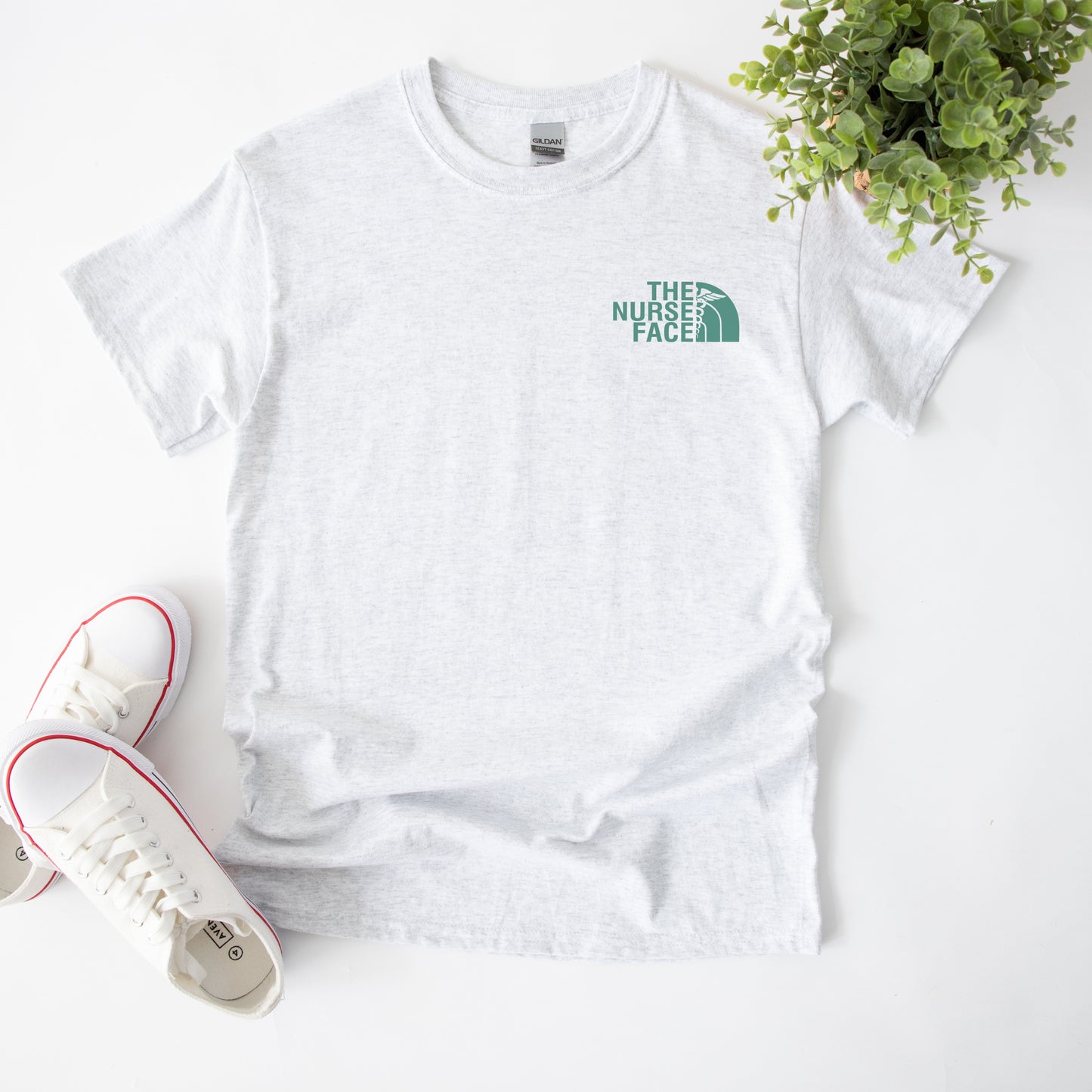 The Nurse Face Teal Left Chest Unisex Tee